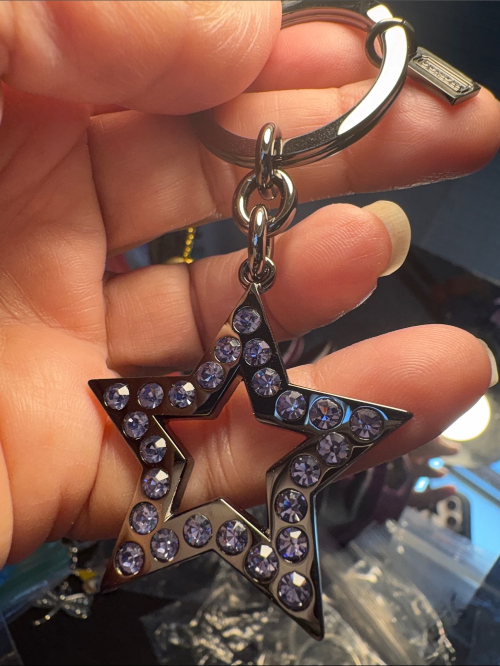 Coach Gunmetal Star Keychain with Purple Crystal Accents